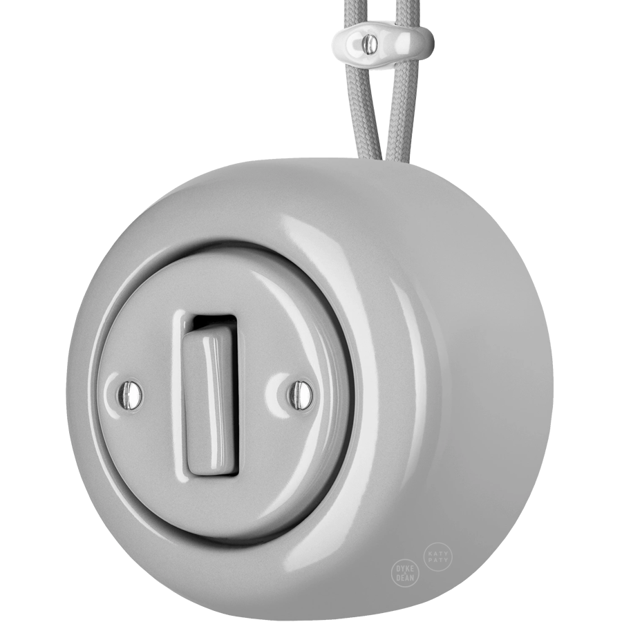 Grey round porcelain surface-mounted slim button switch by Katy Paty